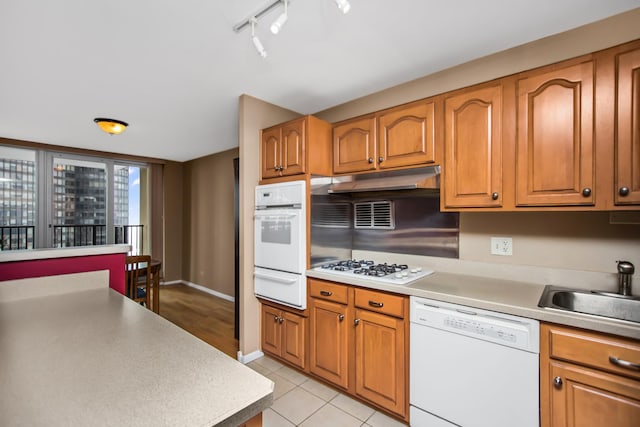 400 E Randolph St Unit 1825, Chicago, IL 60601 - kitchen featuring white appliances, a warming drawer, rail lighting, under cabinet range hood, and light countertops