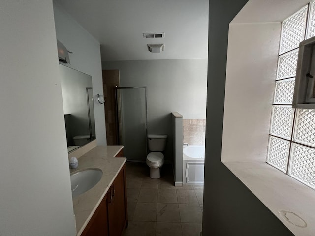 7513 N Winchester Ave Unit 1, Chicago, IL 60626 - bathroom featuring vanity, tile patterned floors, a garden tub, toilet, and an enclosed shower
