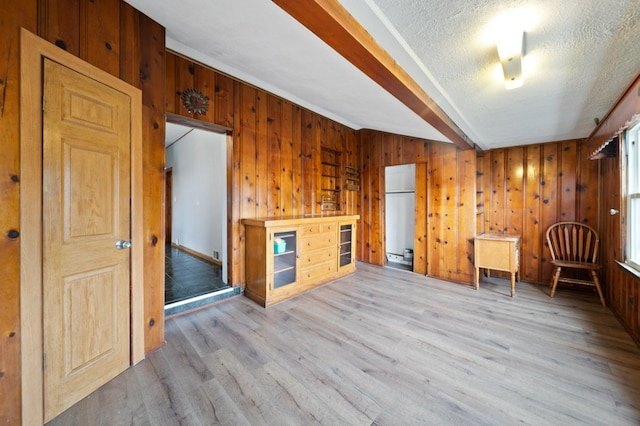 4646 W Montana St, Chicago, IL 60639 - interior space with light wood-type flooring, wooden walls, a textured ceiling, and beam ceiling