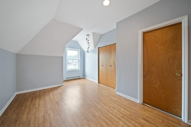 4646 W Montana St, Chicago, IL 60639 - bonus room featuring baseboard heating, wood finished floors, baseboards, and vaulted ceiling