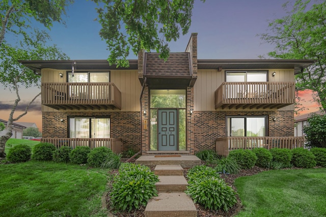 213 Vine St Unit 3, New Lenox, IL 60451 - view of front of property with a balcony, a front lawn, and brick siding