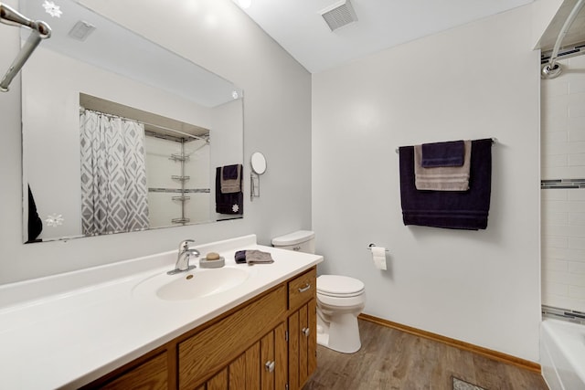 213 Vine St Unit 3, New Lenox, IL 60451 - bathroom featuring toilet, vanity, wood finished floors, shower / bath combo, and baseboards