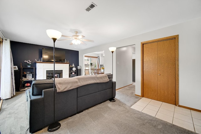 213 Vine St Unit 3, New Lenox, IL 60451 - living area featuring light colored carpet, a glass covered fireplace, ceiling fan, and baseboards
