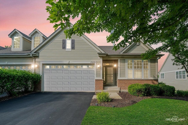 1920 Glenwood Cir Unit B, Sugar Grove, IL 60554 - view of front facade with driveway, brick siding, and a lawn
