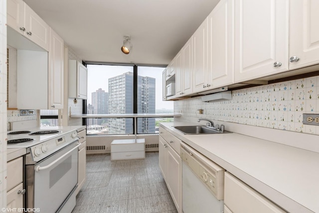 5415 N Sheridan Rd Unit 1601, Chicago, IL 60640 - kitchen featuring white appliances, a sink, white cabinetry, and light countertops