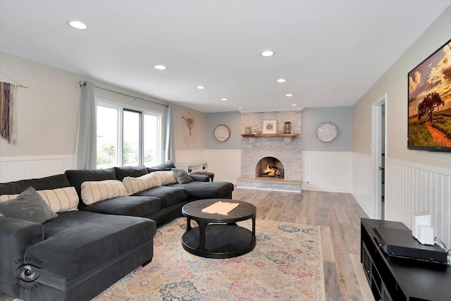 8456 Meadows Edge Trl, Tinley Park, IL 60487 - living room featuring wainscoting, recessed lighting, light wood-style floors, and a large fireplace