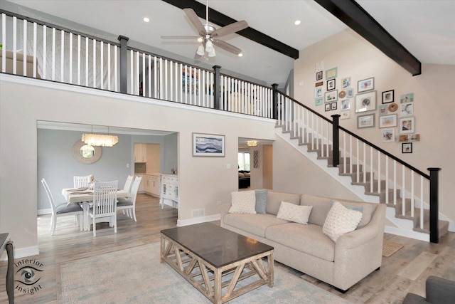 8456 Meadows Edge Trl, Tinley Park, IL 60487 - living room featuring beam ceiling, wood finished floors, stairs, a ceiling fan, and high vaulted ceiling
