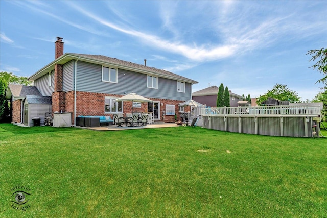 8456 Meadows Edge Trl, Tinley Park, IL 60487 - back of house featuring a chimney, brick siding, a lawn, and a swimming pool