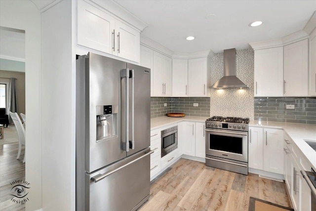 8456 Meadows Edge Trl, Tinley Park, IL 60487 - kitchen with appliances with stainless steel finishes, wall chimney range hood, light countertops, white cabinets, and recessed lighting