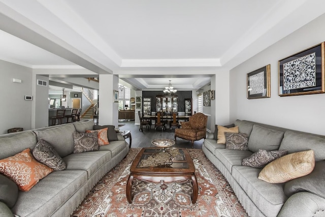 27117 Ashgate Xing, Plainfield, IL 60585 - living area featuring a tray ceiling, a chandelier, stairway, wood finished floors, and ornamental molding