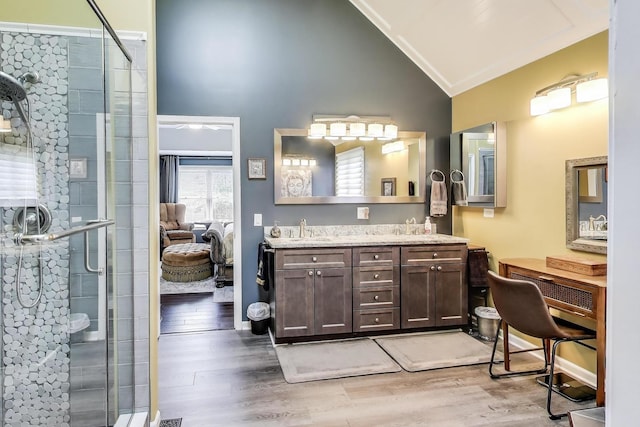 27117 Ashgate Xing, Plainfield, IL 60585 - bathroom featuring double vanity, a shower stall, wood finished floors, high vaulted ceiling, and ensuite bathroom