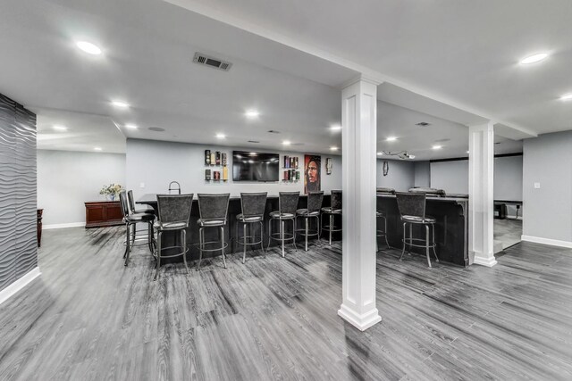 27117 Ashgate Xing, Plainfield, IL 60585 - kitchen with wood finished floors, a breakfast bar, recessed lighting, and decorative columns