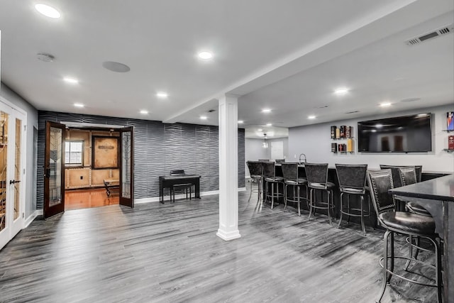 27117 Ashgate Xing, Plainfield, IL 60585 - indoor wet bar featuring wood finished floors, ornate columns, recessed lighting, and wallpapered walls