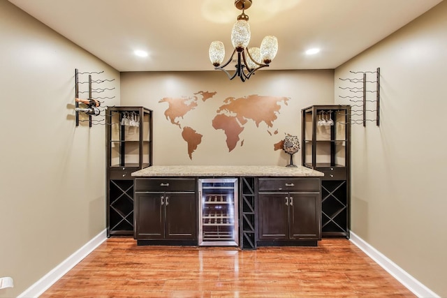 27117 Ashgate Xing, Plainfield, IL 60585 - indoor dry bar featuring wine cooler, a chandelier, light wood-type flooring, pendant lighting, and recessed lighting