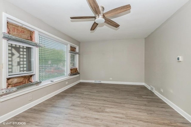 3411 W 59th St, Chicago, IL 60629 - spare room featuring ceiling fan, wood finished floors, and baseboards