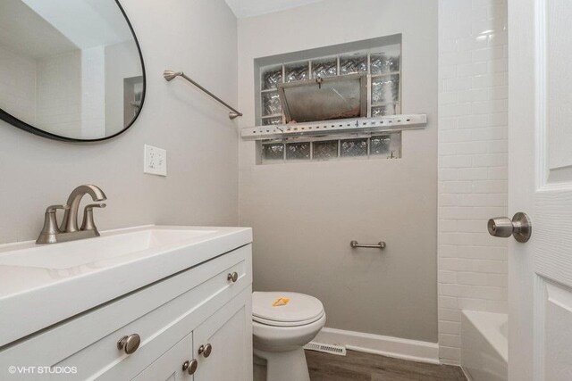 3411 W 59th St, Chicago, IL 60629 - full bath with wood finished floors, toilet, vanity, baseboards, and shower / bathtub combination