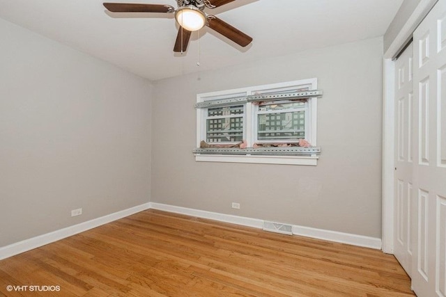 3411 W 59th St, Chicago, IL 60629 - unfurnished bedroom with baseboards, light wood-style floors, and a ceiling fan