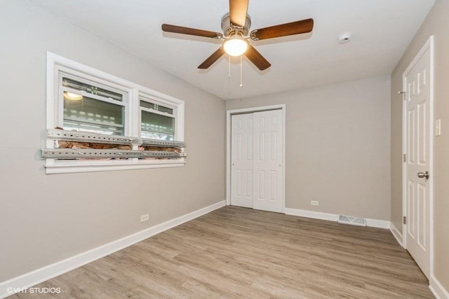 3411 W 59th St, Chicago, IL 60629 - unfurnished bedroom featuring light wood-style floors, a closet, baseboards, and a ceiling fan