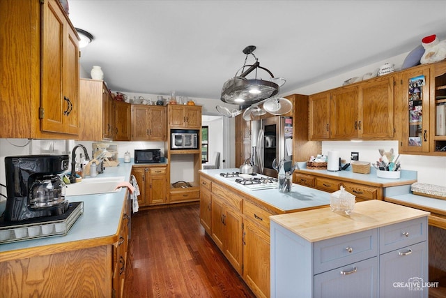 925 Merrill New Rd, Sugar Grove, IL 60554 - kitchen with stainless steel appliances, a kitchen island, dark wood-style flooring, brown cabinets, and decorative light fixtures