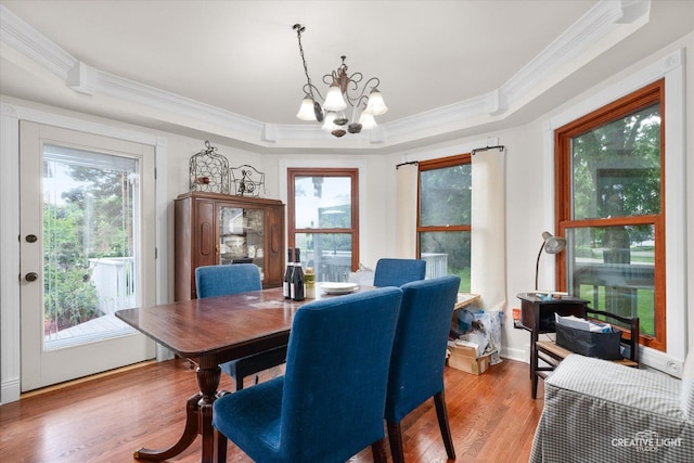 925 Merrill New Rd, Sugar Grove, IL 60554 - dining space with ornamental molding, a chandelier, a tray ceiling, and light wood-type flooring