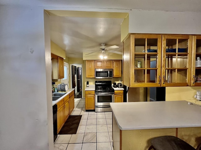 17552 State Line Ave, Lansing, IL 60438 - kitchen with stainless steel appliances, light countertops, a ceiling fan, light tile patterned floors, and glass insert cabinets