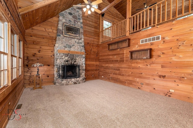 2622 E 28th Rd, Marseilles, IL 61341 - unfurnished living room with a wood ceiling with exposed beams, ceiling fan, a fireplace, wooden walls, and carpet floors