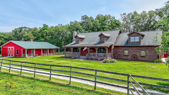 2622 E 28th Rd, Marseilles, IL 61341 - view of front of home featuring log exterior, a porch, an outbuilding, a chimney, and a pole building