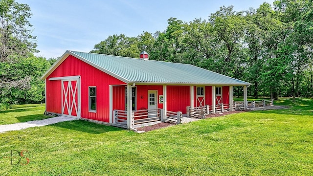 2622 E 28th Rd, Marseilles, IL 61341 - view of front facade featuring a front lawn, a metal roof, and view of wooded area