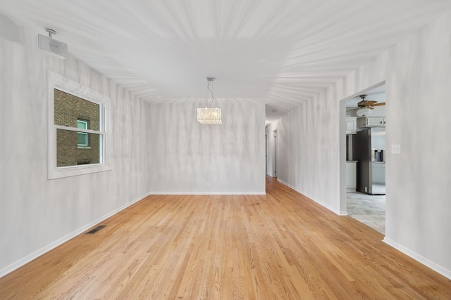 1094 E Algonquin Rd, Des Plaines, IL 60016 - unfurnished room featuring light wood-style floors, baseboards, and a chandelier