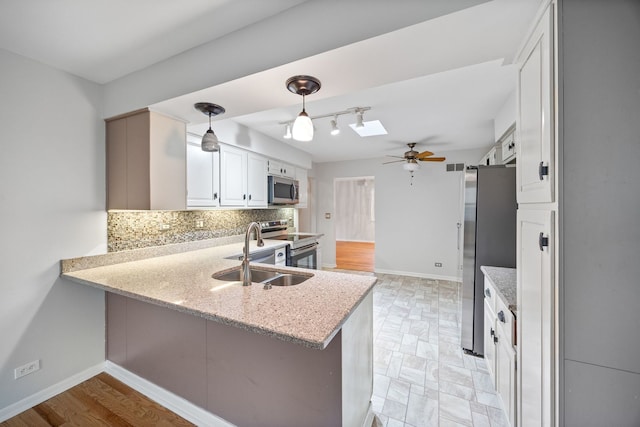 1094 E Algonquin Rd, Des Plaines, IL 60016 - kitchen featuring appliances with stainless steel finishes, a sink, ceiling fan, decorative backsplash, and white cabinets