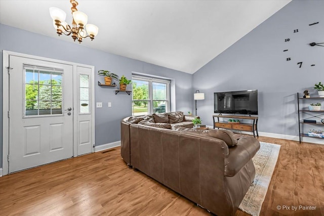 688 Regent Dr, Crystal Lake, IL 60014 - living room with a chandelier, light wood-style flooring, and high vaulted ceiling