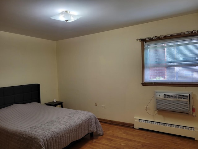 3023 Paris Ave Unit 207, River Grove, IL 60171 - bedroom featuring baseboard heating, wood finished floors, baseboards, and a wall mounted AC