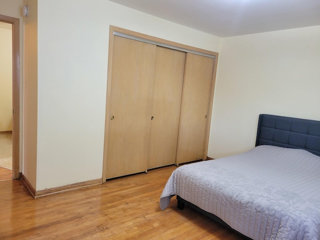 3023 Paris Ave Unit 207, River Grove, IL 60171 - bedroom featuring a closet, light wood-type flooring, and baseboards