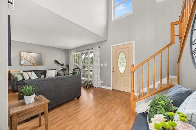 2278 Andrew Trl, Montgomery, IL 60538 - entrance foyer with healthy amount of natural light, stairs, light wood-type flooring, and a towering ceiling