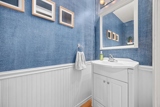 2278 Andrew Trl, Montgomery, IL 60538 - bathroom featuring vanity, wainscoting, and a decorative wall