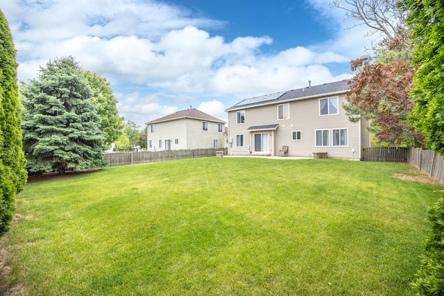 2278 Andrew Trl, Montgomery, IL 60538 - rear view of property with roof mounted solar panels, a patio, and a fenced backyard