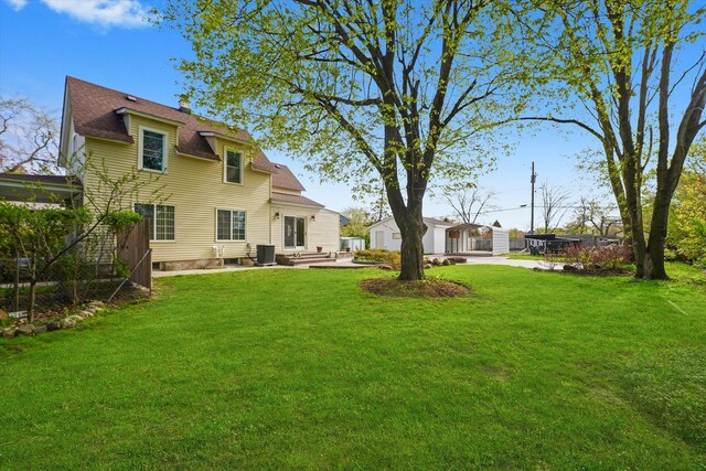 2203 Gilead Ave, Zion, IL 60099 - view of grassy yard featuring a patio and central AC
