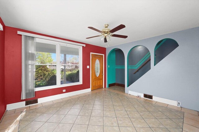2203 Gilead Ave, Zion, IL 60099 - tiled spare room with baseboards, ceiling fan, and arched walkways
