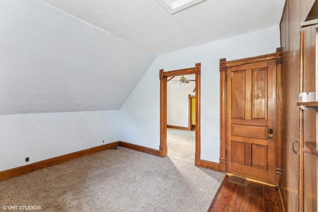 309 E Corning Ave, Peotone, IL 60468 - additional living space featuring lofted ceiling, baseboards, and dark colored carpet