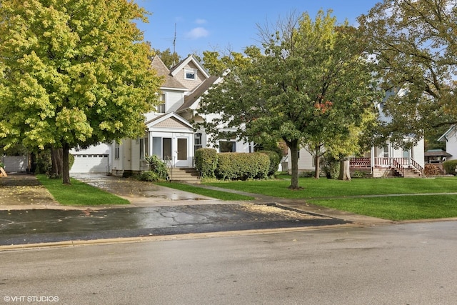 309 E Corning Ave, Peotone, IL 60468 - view of property hidden behind natural elements with french doors, a front lawn, a garage, and concrete driveway