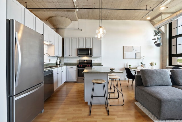 3963 W Belmont Ave Unit 422, Chicago, IL 60618 - kitchen with stainless steel appliances, a sink, rail lighting, open floor plan, and backsplash