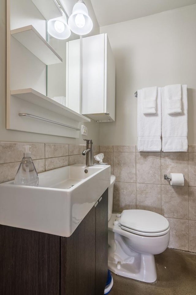 3608 W Dickens Ave Unit 1W, Chicago, IL 60647 - half bathroom with tile walls, toilet, wainscoting, and vanity