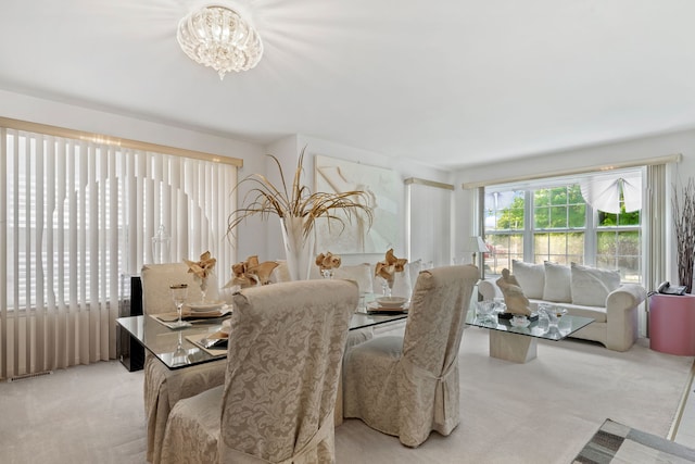6941 S E End Ave, Chicago, IL 60649 - dining area featuring light carpet and a chandelier