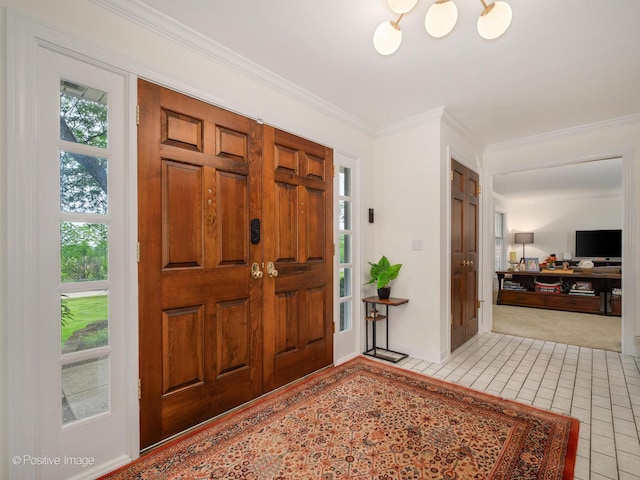 77 Mark Dr, Hawthorn Woods, IL 60047 - foyer entrance featuring light tile patterned flooring, ornamental molding, light colored carpet, and a chandelier