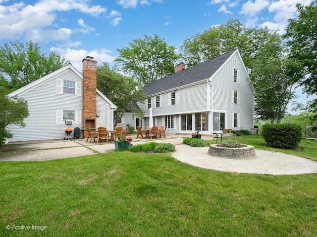 77 Mark Dr, Hawthorn Woods, IL 60047 - rear view of house featuring a fire pit, a patio, a lawn, roof with shingles, and a chimney