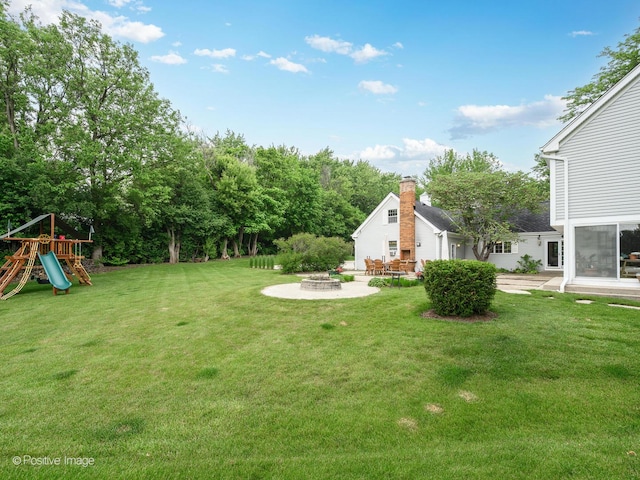 77 Mark Dr, Hawthorn Woods, IL 60047 - view of green lawn with a fire pit, a playground, and a patio