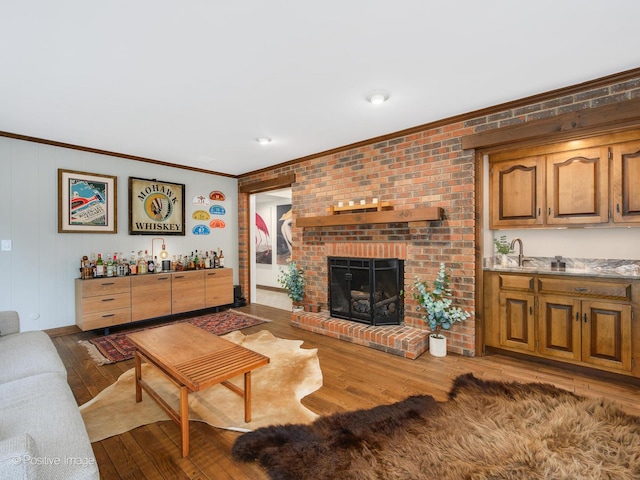 77 Mark Dr, Hawthorn Woods, IL 60047 - living area with bar with sink, crown molding, hardwood / wood-style floors, and a brick fireplace