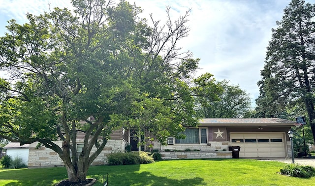 205 Beacon Dr, Belvidere, IL 61008 - view of front of house with stone siding, an attached garage, a front yard, and driveway