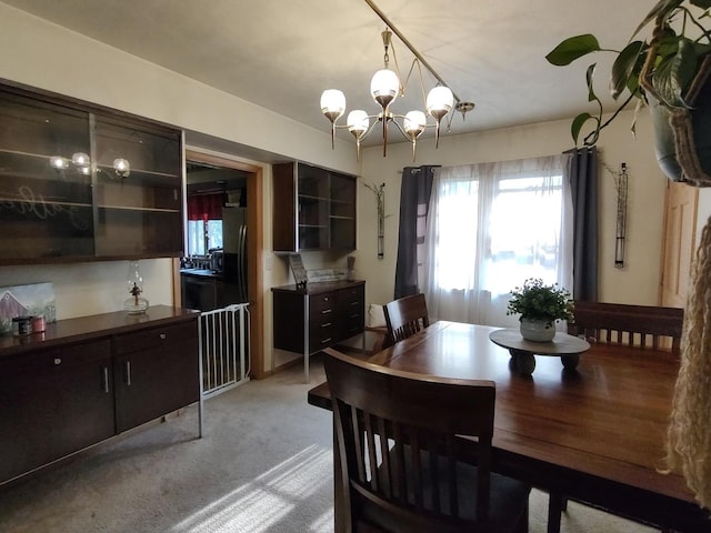 205 Beacon Dr, Belvidere, IL 61008 - dining area featuring a chandelier and light colored carpet