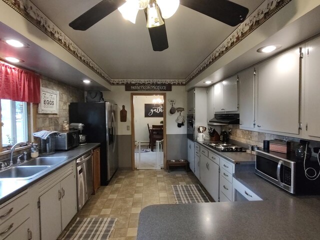 205 Beacon Dr, Belvidere, IL 61008 - kitchen with black appliances, a sink, under cabinet range hood, decorative backsplash, and dark countertops
